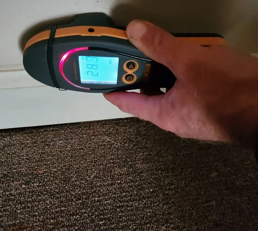 Moisture detection at baseboard during Storm Damage Restoration in Rushville